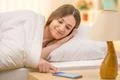 The woman with a phone on the bed Photo