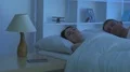 The woman phone near the man on the bed. Camera around motion 4k or 4k+ Resolution