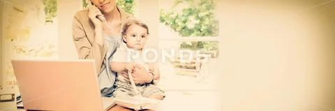 Woman on phone while taking care of baby Stock Photos