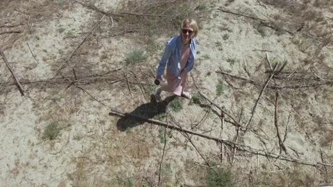 Woman pick up plastic garbage on sandy beach of the sea. Spilled garbage on Stock Footage 163527770