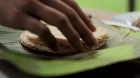 Woman picking up flat bread Stock Footage 48734120