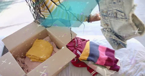 Woman picking jacket and sorting garments on bed while animated icons guiding Stock Footage 314739066