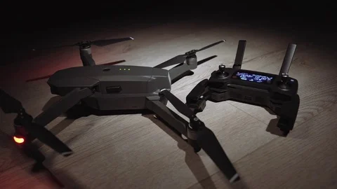 The woman picks up the remote control panel for the quadrocopter drone Video stock 81267816