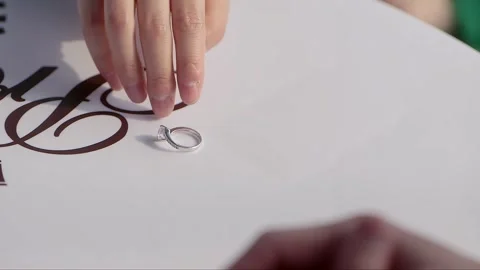 The woman picks up the ring placed on the table Stock Footage 261642108