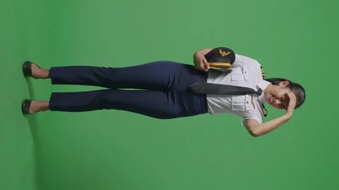 Woman Pilot Having A Headache While Standing In The Green Screen Background Stock Footage 251644437