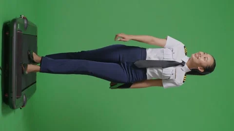 Woman Pilot Holding A Tablet While Walking On Treadmill In The Green Screen Stock Footage 251686059