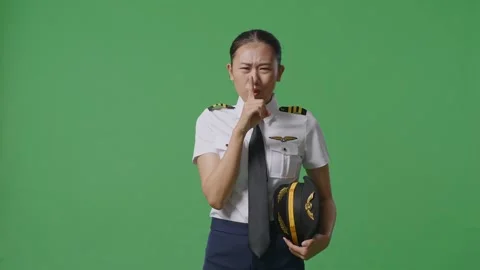 Woman Pilot Looking At Camera And Making Shh Gesture In The Green Screen Stock Footage 251641353