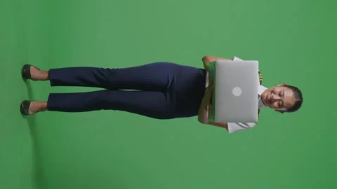 Woman Pilot Smiling And Using A Laptop While Standing In The Green Screen Stock Footage 251645502