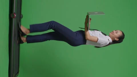 Woman Pilot Smiling And Using Laptop While Walking On Treadmill On  Green Screen Stock Footage 251686483