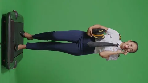 Woman Pilot Talking On Smartphone While Walking On Treadmill In The Green Screen Stock Footage 251685979