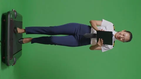 Woman Pilot Using A Tablet While Walking On Treadmill In The Green Screen Stock Footage 251686007