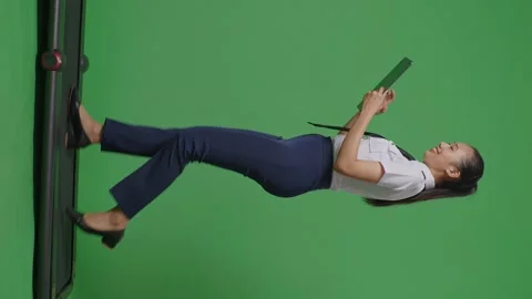 Woman Pilot Using A Tablet While Walking On Treadmill In The Green Screen Stock Footage 251686402