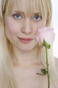 Woman with pink rose Stock Photos