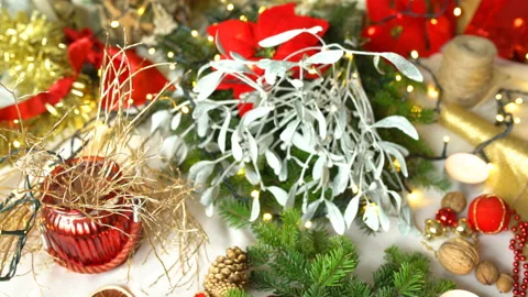 Woman pins ball while making christmas floral decoration, steadycam shot Stock Footage 99221021