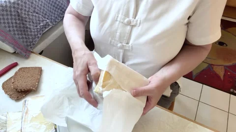 Woman Placing Packaged Cheese on a Kitchen Table Before Breakfast Stock Footage 342017975