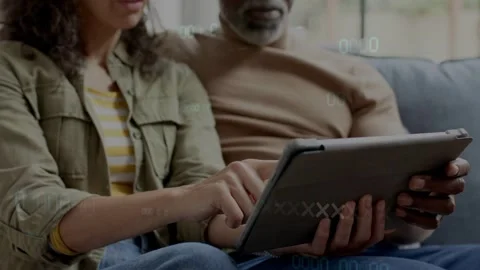 Woman placing tablet while man holding, woman tapping or swiping, timecode Stockbeeldmateriaal 333704364