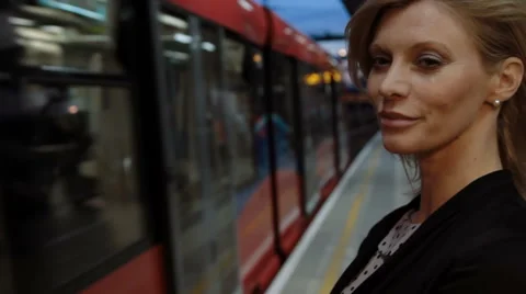 Woman on platform as train arrives Stock Footage 40107366