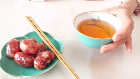 Woman plating Chinese meatballs to delicate porcelain dish Stock Footage 132696853