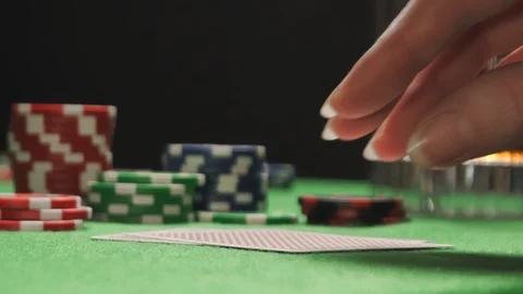 A woman player checking her hand, having a pair of aces, winning poker game Stock Footage 126007397