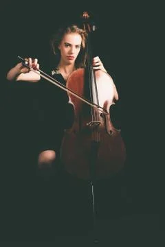 Woman Playing a Cello Instrument Looking at Camera Stock Photos