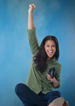 Woman playing with computer game controller with blue fog background Stock Photos