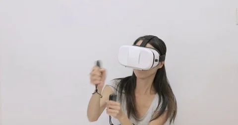 Woman playing game with virtual reality device Stock Footage