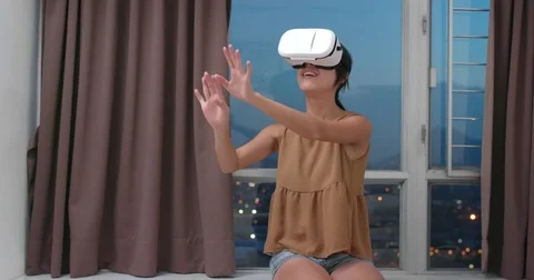 Woman playing game with VR device at home Stock Footage 80682879