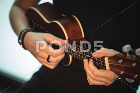 Woman Playing A Guitar In Music School