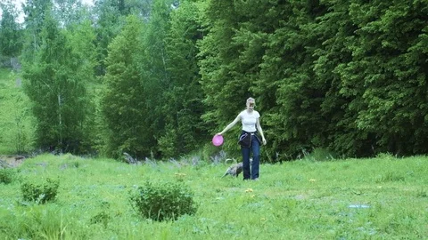 Woman playing with her border collie dog, throwing the frisbee 4k Stock Footage
