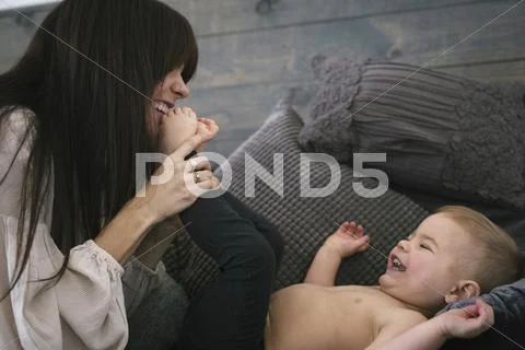 A woman playing with her young son. Stock Photos