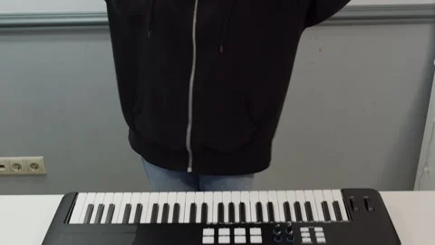 Woman playing keyboard while dancing at studio Stock Footage 301274328