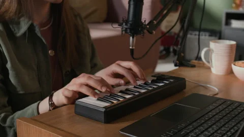 Woman Playing MIDI Keyboard while Recording Electronic Music in Home Studio Stock Footage 335397516