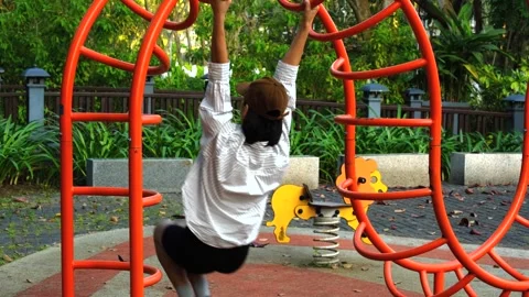 Woman Playing on Outdoor Monkey Bars in Park Stock Footage 334907787