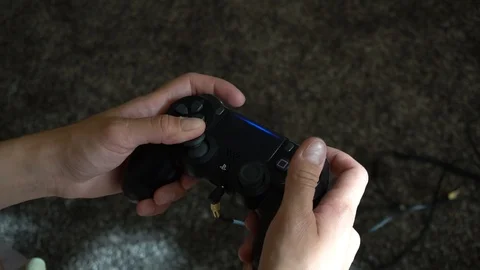 Woman playing on PS4 game controller Stock Footage 94759726