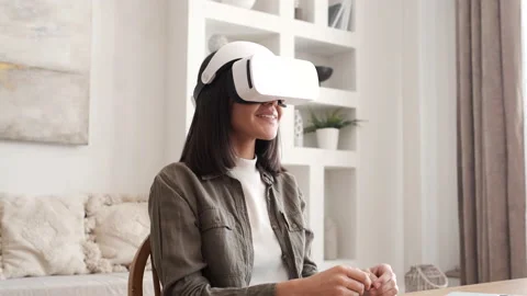 Woman playing using VR goggles at home. Girl wearing virtual reality headset. Stock Footage 178899570