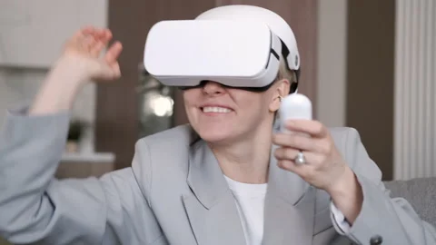 Woman playing using VR goggles at home. New technologies. The future is now 4K Video stock 181881641