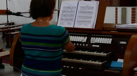 Woman playing worship song by the church organ during the world youth day Stock Footage