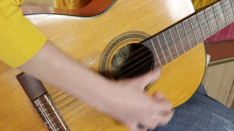 A woman plays the guitar, knocks on the strings Stock Footage 161223984