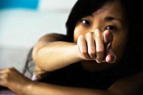 Woman pointing accusingly at camera Stock Photos