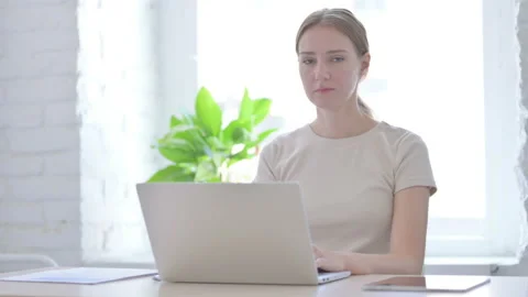 Woman Pointing at Camera while using Laptop Video stock 205000738