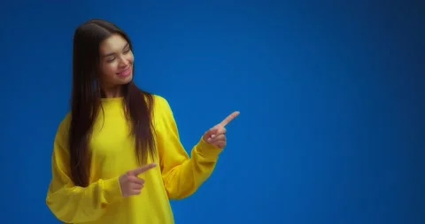 Woman pointing to an empty space on the right for your advertising content. Stock Footage 195935446