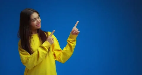 Woman pointing to an empty space on the right for your advertising content. Stock Footage 195935468