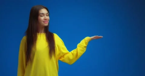 Woman pointing to an empty space on the right for your advertising content. Stock Footage 195935501