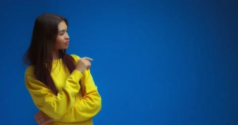 Woman pointing to an empty space on the right for your advertising content. Stock Footage 195935585