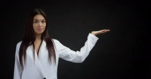 Woman pointing to an empty space for your advertising content. Stock Footage 170197058