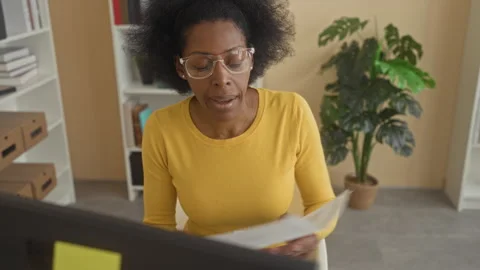 Woman pointing pen to chart on performance report at computer in building; .. Stock Footage 337377925