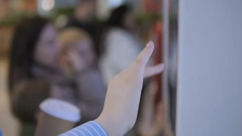 Woman is pointing at something on a wall Stock Footage 306575936