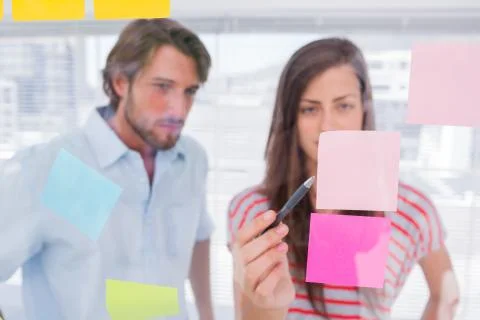 Woman pointing a sticky note Stock Photos