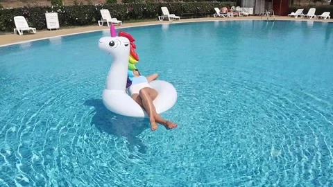 Woman on pool float in pool in hotel. Summer holidays, enjoying summer vacat Stock Footage 268448858