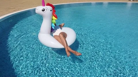 Woman on pool float in pool in hotel. Summer holidays, enjoying summer vacat 動画素材 268448863